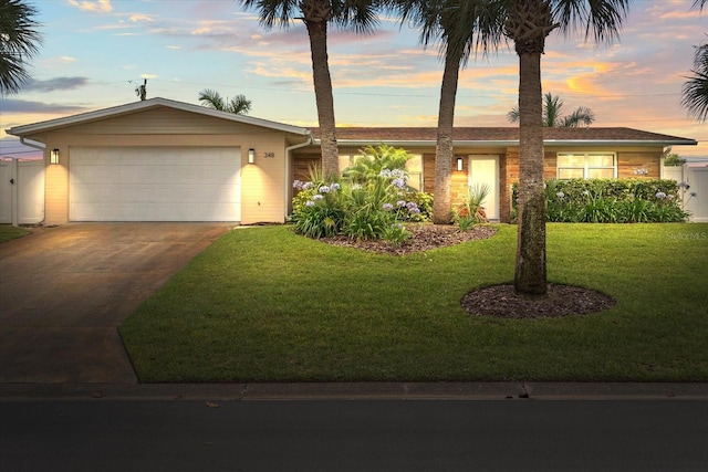 view of front of home with a yard and a garage