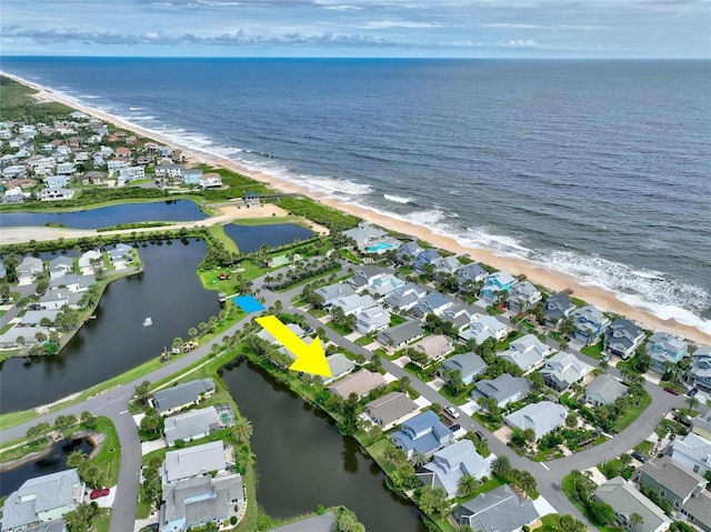 aerial view featuring a view of the beach and a water view