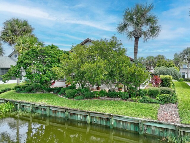 exterior space with a water view and a yard