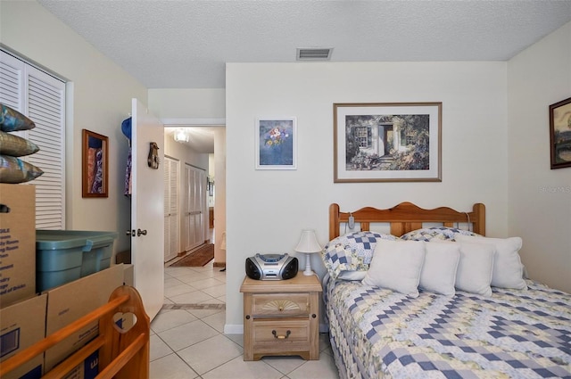 8 Sea Vista Dr, Palm Coast, FL 32137 - bedroom with light tile patterned flooring, a textured ceiling, and visible vents