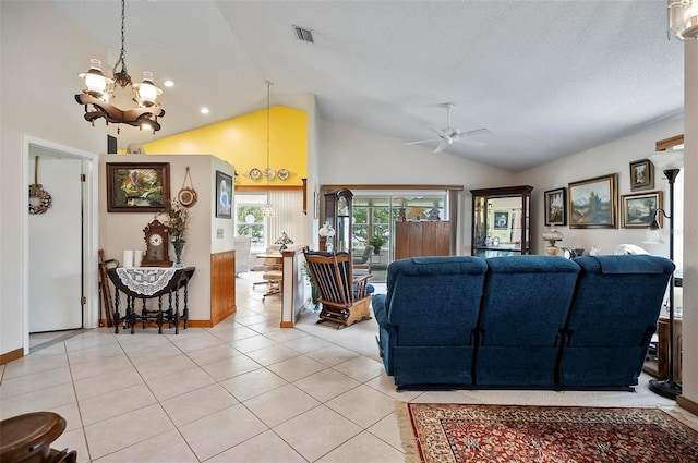 living room with high vaulted ceiling, ceiling fan with notable chandelier, light tile patterned floors, and a textured ceiling