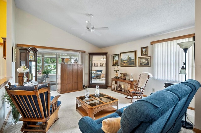 living room with high vaulted ceiling, ceiling fan, light carpet, and a textured ceiling