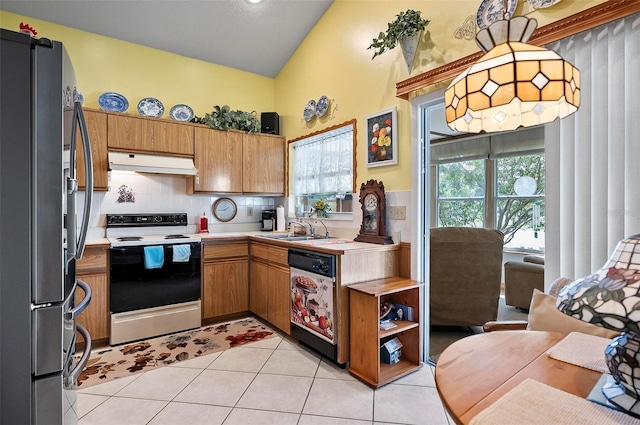 kitchen featuring backsplash, light tile patterned floors, vaulted ceiling, appliances with stainless steel finishes, and sink