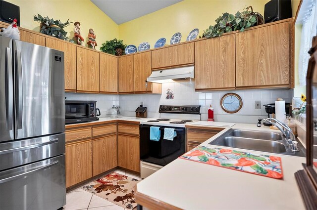 kitchen with stainless steel refrigerator, sink, electric stove, light tile patterned flooring, and tasteful backsplash