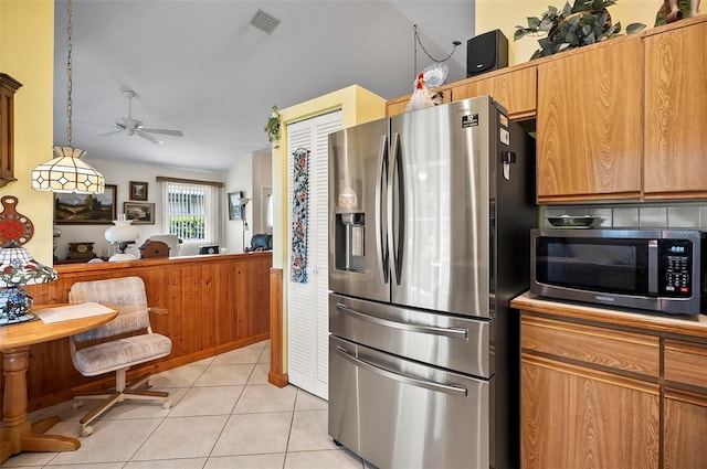 kitchen featuring pendant lighting, backsplash, stainless steel appliances, light tile patterned floors, and ceiling fan