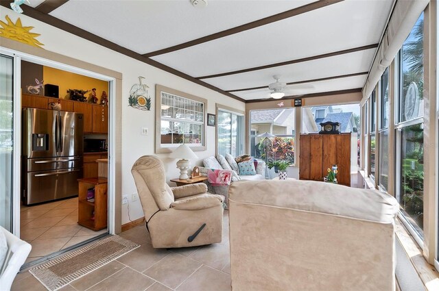 sunroom / solarium featuring ceiling fan