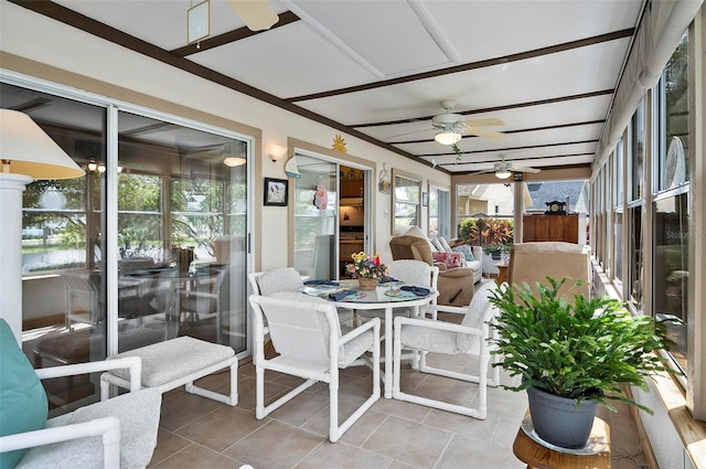 sunroom featuring ceiling fan