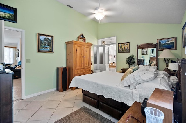 bedroom with lofted ceiling, ceiling fan, light tile patterned floors, and ensuite bath