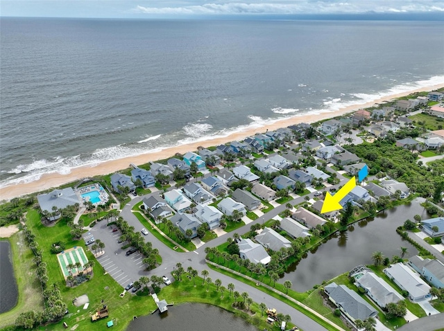 drone / aerial view featuring a view of the beach and a water view