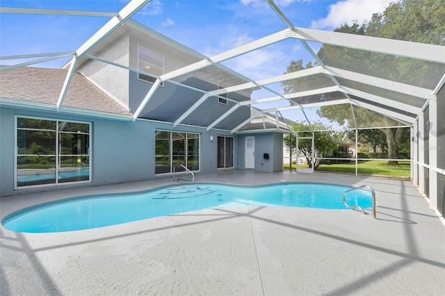 view of swimming pool featuring a patio and a lanai