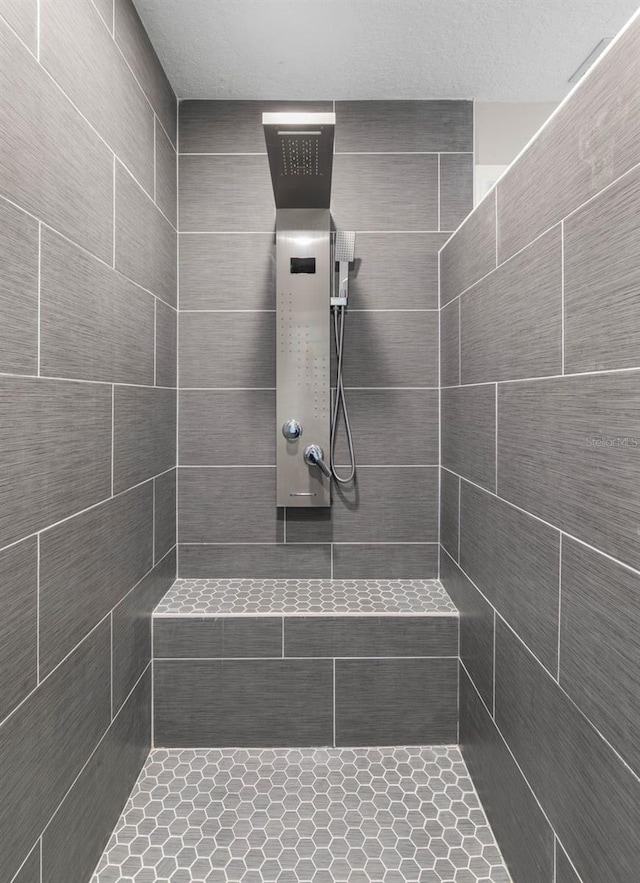 bathroom with tiled shower