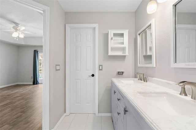 bathroom featuring vanity, a textured ceiling, wood-type flooring, and ceiling fan