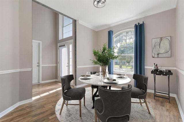 dining space with french doors, hardwood / wood-style flooring, and ornamental molding