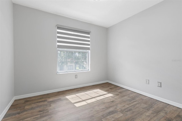 unfurnished room featuring dark wood-type flooring