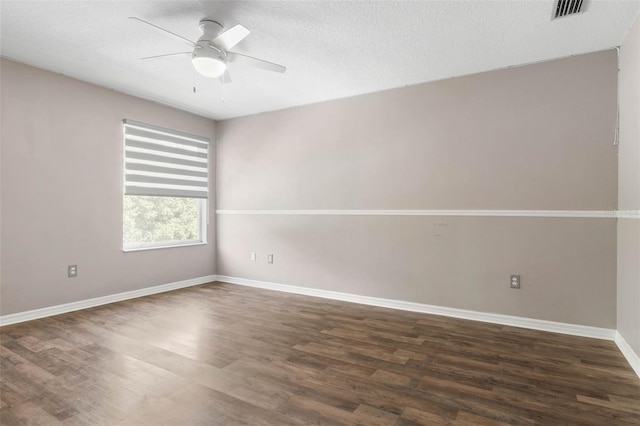 empty room featuring a textured ceiling, ceiling fan, and dark hardwood / wood-style flooring