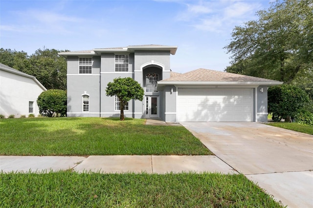 view of front of house featuring a garage and a front lawn