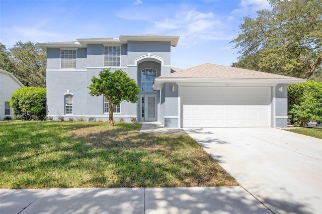 view of front of home with a garage and a front lawn