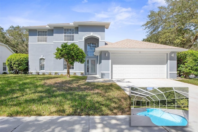 view of front of property with a front yard and a garage