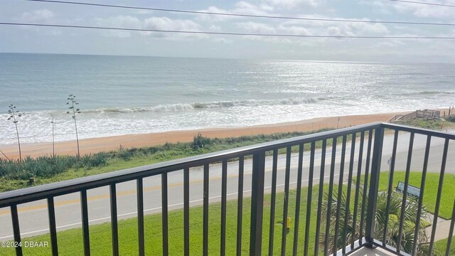 balcony featuring a beach view and a water view