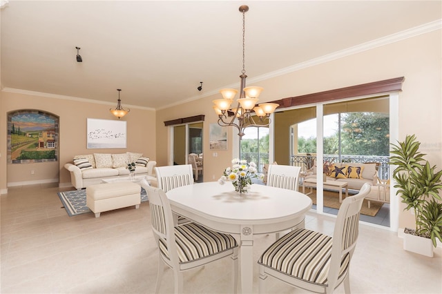 dining space with ornamental molding and an inviting chandelier