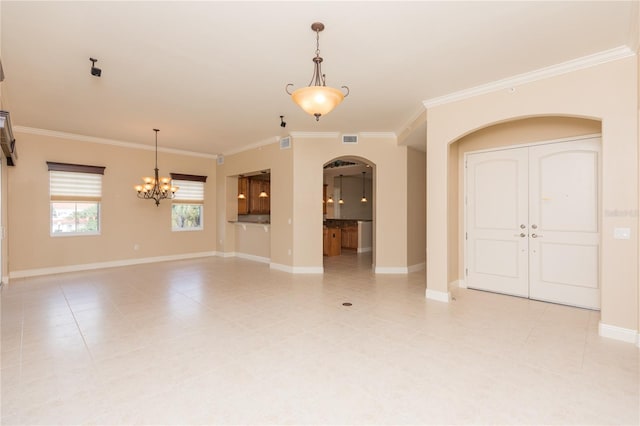 tiled spare room with a chandelier and ornamental molding