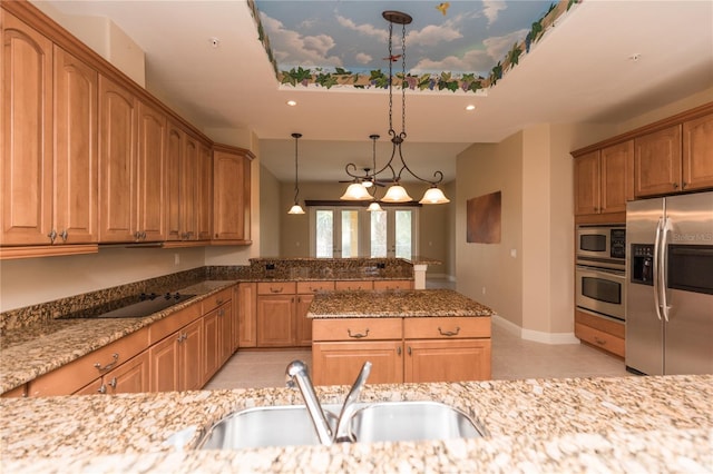 kitchen with hanging light fixtures, light tile patterned floors, sink, stainless steel appliances, and light stone countertops