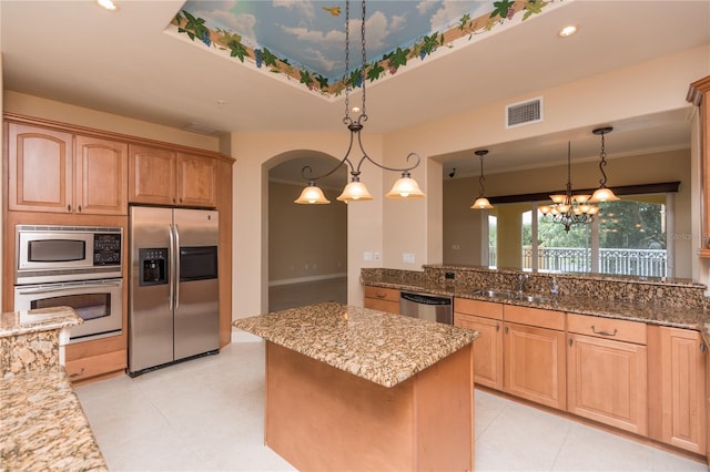 kitchen featuring pendant lighting, stainless steel appliances, and stone counters