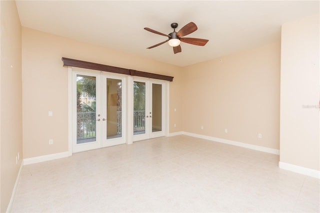 empty room featuring ceiling fan and french doors