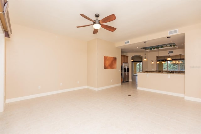 unfurnished living room with ceiling fan