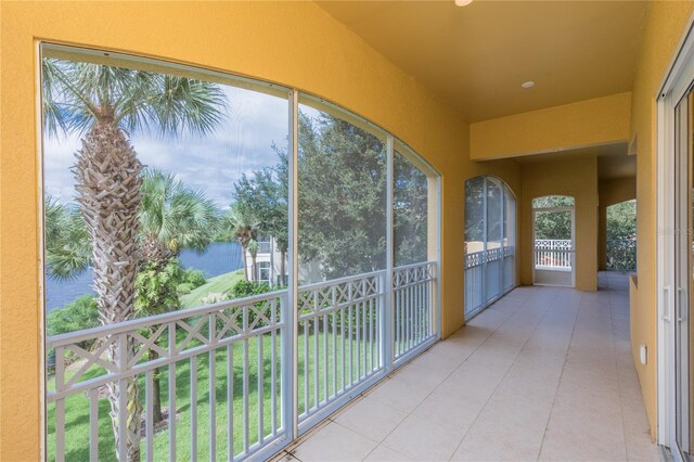 unfurnished sunroom featuring a water view