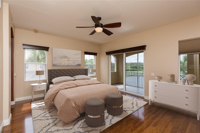 bedroom featuring dark hardwood / wood-style flooring, ceiling fan, and access to exterior