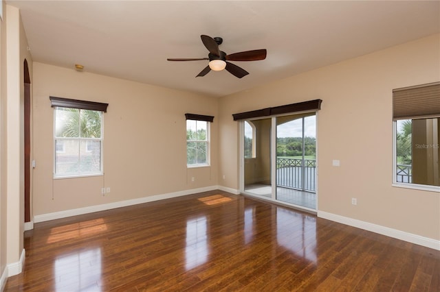 unfurnished room with ceiling fan and dark wood-type flooring