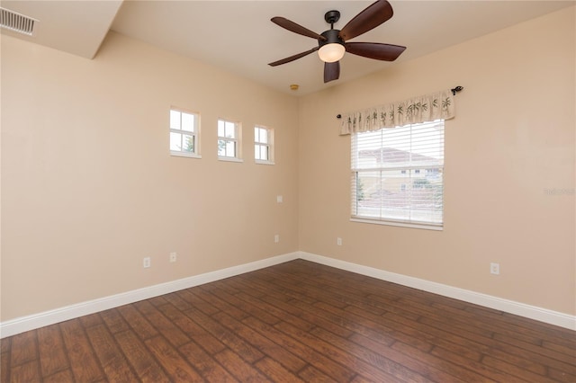 spare room with dark wood-type flooring and ceiling fan