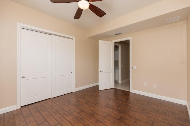 unfurnished bedroom featuring a closet, ceiling fan, and dark wood-type flooring