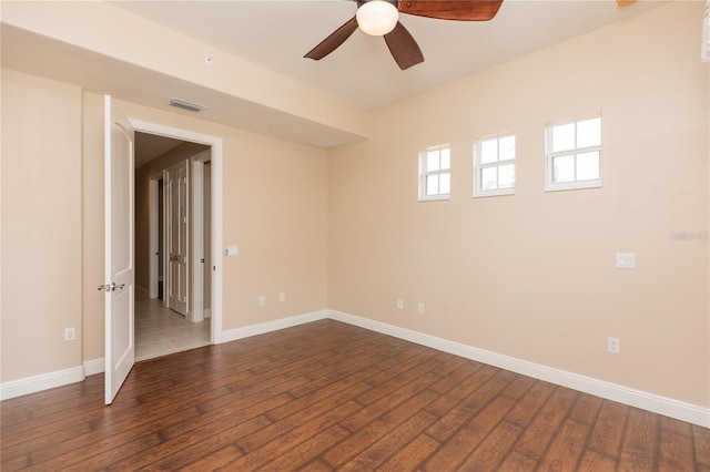 spare room featuring ceiling fan and dark hardwood / wood-style floors