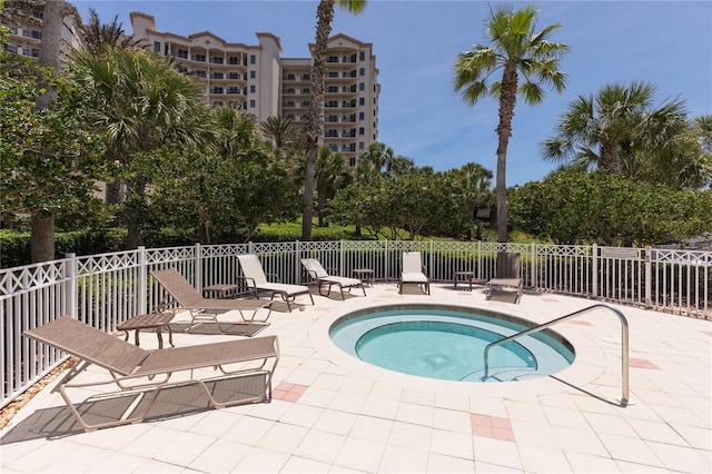 view of pool with a patio and a hot tub