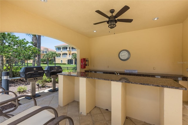 view of patio featuring ceiling fan and a grill