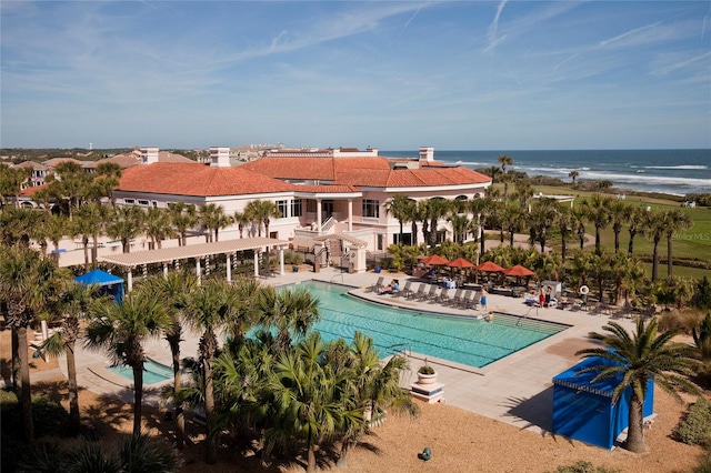 view of pool featuring a water view and a patio area