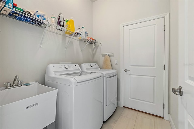 washroom featuring washer and dryer and sink