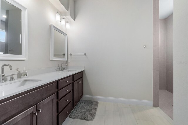 bathroom featuring a tile shower and vanity