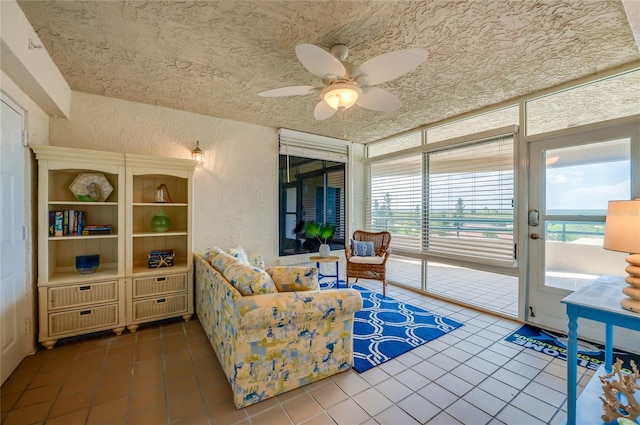 living room featuring ceiling fan and tile patterned floors