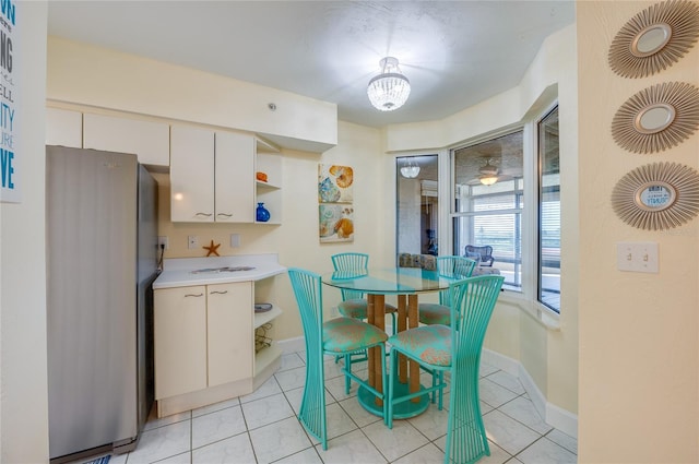 dining room with a chandelier and light tile patterned flooring