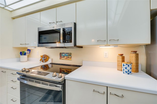 kitchen featuring white cabinets and appliances with stainless steel finishes