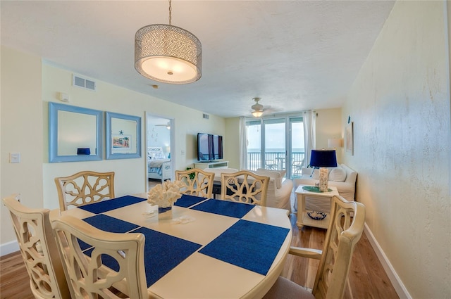 dining room featuring hardwood / wood-style floors and ceiling fan