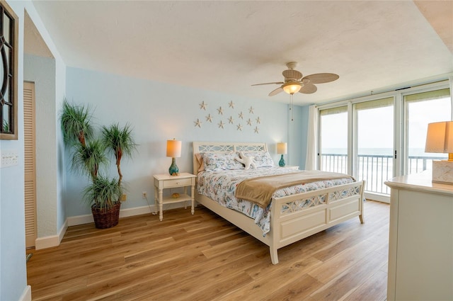 bedroom with light wood-type flooring, ceiling fan, and access to outside