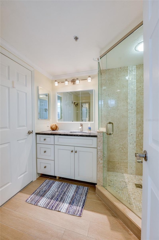 bathroom featuring walk in shower, wood-type flooring, and vanity