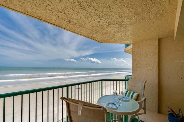 balcony with a view of the beach and a water view