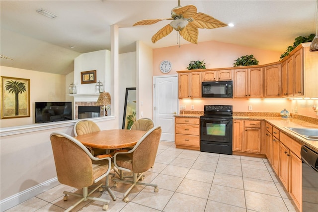 kitchen with black appliances, ceiling fan, light tile patterned floors, and vaulted ceiling