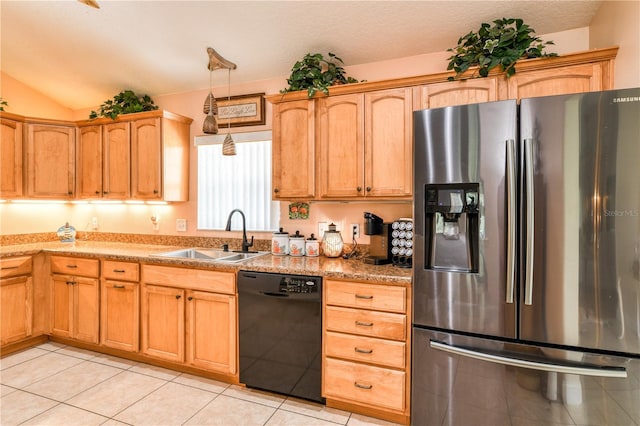 kitchen featuring hanging light fixtures, dishwasher, sink, stainless steel fridge, and light tile patterned flooring