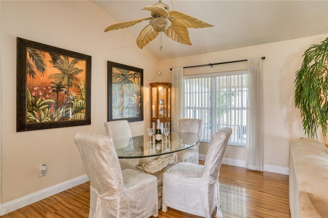 dining room featuring lofted ceiling, light hardwood / wood-style flooring, and ceiling fan